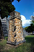 Chichen Itza - El Osario pyramid (the Ossuary). Part of the decoration of the top of the structure consisted of stacked masks in Puuc style. They may represent rain gods (Chac).