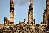 Chichen Itza - The Templo de los Guerreros (Temple of the Warriors). The upper esplanade with the Chak-mol statue in between two pillars in the form of serpents.