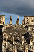 Chichen Itza - The Templo de los Guerreros (Temple of the Warriors). The upper esplanade with the Chak-mol statue in between two pillars in the form of serpents.