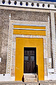 Izamal - low Spanish colonial houses, most of the buildings facades are painted a glowing ochre colour.