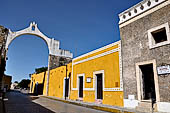 Izamal - low Spanish colonial houses, most of the buildings facades are painted a glowing ochre colour.