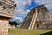 Uxmal - The west face of the The Magician Pyramid (el Adivino) seen from the Quadrangle of the Birds (Cuadrangulo de los Pajaros). 