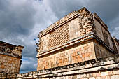 Uxmal - The Nunnery Quadrangle. The South end of the Eastern building. Corner masks stack.