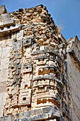 Uxmal - The Nunnery Quadrangle. The Eastern building. Masks stack of the S-E corner.