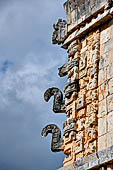 Uxmal - The Nunnery Quadrangle. Masks stack of the S-W corner of the Eastern building. These are the only 2 snouts on East Building; these snouts turning upward.