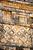 Uxmal - The Nunnery Quadrangle. The West building. Detail of sculpture medallion showing a god emerging from a flower.