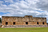 Uxmal - The Nunnery Quadrangle. East Building: front (west) facade; the centre is marked by a mask stack.