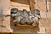 Uxmal - The Nunnery Quadrangle, the North Building. The frieze over the fifth doorway: two jaguars with intertwined tails.