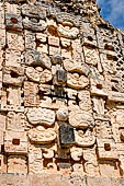 Uxmal - The Nunnery Quadrangle, the North Building. the second  mask stack (from left) the three surviving  masks stack each with similar features and round eyebrows.