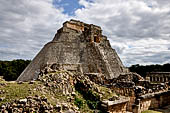 Uxmal - The west face of the  Magician Pyramid (el Adivino) seen from the Quadrangle of the Birds (Cuadrangulo de los Pajaros). 