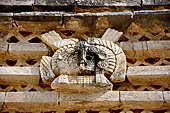 Uxmal - The Nunnery Quadrangle. The Eastern building. Detail of the trapezoidal frieze of the facade showing a owl head.