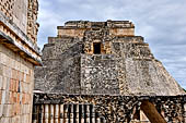 Uxmal - The west face of the  Magician Pyramid (el Adivino) seen from the Quadrangle of the Birds (Cuadrangulo de los Pajaros). 