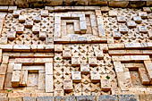 Uxmal - Palace of the Governor, front (East) facade. The frieze represents 'meanders' which rotate in different directions with lattice panels and square steps.