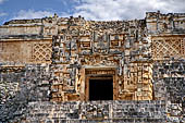 Uxmal - Pyramid of the Magician (Adivino). Temple IV: enormous zoomorphic mask with entrance to temple as a mouth; stack of 8 masks on each corners.