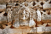 Uxmal - The Nunnery Quadrangle. The Eastern building. Detail of the trapezoidal frieze of the facade showing a owl head.