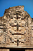 Uxmal - The Nunnery Quadrangle, the North Building. The third masks stack from left, on top it can be noted a partially preserved mask of Tlaloc.