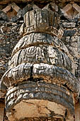 Uxmal - The Nunnery, West building. The frieze above the central door:  large feathered headdress above the turtle-man deity; note the top headband with 3 faces.