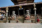 Bhaktapur - Tachupal Tole. Dattatraya Temple. Statue of wrestlers guarding the temple. 