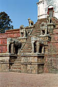 Bhaktapur - Durbar Square - Fasidega Temple (Shiva) on the eastern esplanade of the square, a white sikkara  on top of a platform with stairway flanked by cows and elephants. 