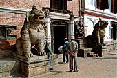 Bhaktapur - Durbar Square - Big lion statue of the entrance of the West wing of the Real Palace (now an art gallery) in between the  stone images of Hanuman and Narsingha. 