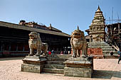 Bhaktapur - Durbar Square - the two isolated lion statues in the middle of the east end of the square, with behind the Siddhi Lakshmi temple.