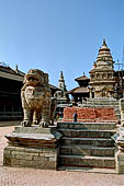 Bhaktapur - Durbar Square - the two isolated lion statues in the middle of the east end of the square, with behind the Siddhi Lakshmi temple.