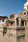 Bhaktapur - Durbar Square - Fasidega Temple (Shiva) on the eastern esplanade of the square, a white sikkara  on top of a platform with stairway flanked by cows and elephants.