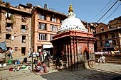 Bhaktapur - Golmadhi Square, where there is a deep hiti and the small three tiered temple dedicated to Golmadhi Ganesh and, nearby, a white chaitya.