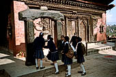 Gokarna Mahadev - South side of the temple with in front a stone torana holding a bronze bell.