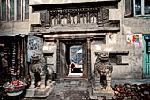 Kathmandu - Stone lions at the entrance of Musya Bahal.