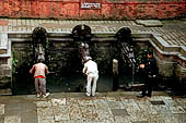 Patan Durbar Square - Manga Hiti the large pool at the Northern side of the square, with the three finely carved water sprouts.