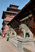 Patan Durbar Square - The stone lions guarding the entrance to the Mul Chowk with behind the big Dejutaleju temple.