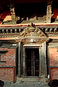 Patan Durbar Square - the N-W end of the square with the Ganesh temple, detail of the temple entrance. 