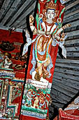 Patan - South of Durbar Square, the temple of Rato Machhendra Nath. The roof struts depict Avalokiteswara standing above figures being tortured in hell. 