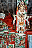 Patan - South of Durbar Square, the temple of Rato Machhendra Nath. The roof struts depict Avalokiteswara standing above figures being tortured in hell. 