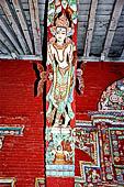 Patan - South of Durbar Square, the temple of Rato Machhendra Nath. The roof struts depict Avalokiteswara standing above figures being tortured in hell. 