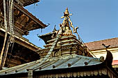 Patan  - The Golden Temple, the small pagoda inside the courtyard, four nagas support a small pinnacle with the 13 rings.