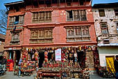 Swayambhunath Hill - Nepali building nearby the statue of the Buddha of light.