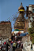 Swayambhunath Stupa - Pilgrims reach the top of the 365 steps of the eastern stairway climbing the hill.