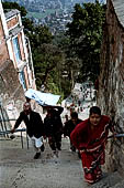 Swayambhunath Stupa - Pilgrims reach the top of the 365 steps of the eastern stairway climbing the hill.