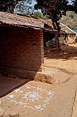 Orissa Koraput district - Auspicious floor painting in front of a village house at the Ankadeli market.