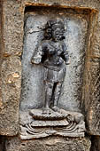 Hirapur - the Sixtyfour Yoginis Temple, Yogini n 5 (clockwise), two armed standing on a lotus. Note the armlets of cobra.