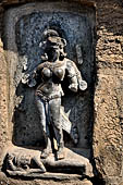 Hirapur - the Sixtyfour Yoginis Temple, Yogini n 1 (clockwise), four armed standing on a corpse. Note the ear ornament.