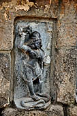 Hirapur - the Sixtyfour Yoginis Temple, Yogini n 10 (clockwise), two armed standing on a serpent. She has a garland of corpses and holds a khadga.