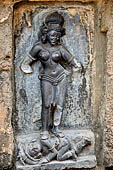 Hirapur - the Sixtyfour Yoginis Temple, Yogini n 15 (clockwise), two armed figure standing on a demon with a dagger and holding a stem of lotus.