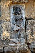 Hirapur - the Sixtyfour Yoginis Temple, Yogini n 21 (clockwise), two armed graceful figure mounted on a dog, she is adjusting her anklets.