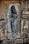 Hirapur - the Sixtyfour Yoginis Temple, Yogini n 22 (clockwise), standing on a serpent a four armed figure with a string instrument over the shoulder.