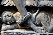 Hirapur - the Sixtyfour Yoginis Temple, eastern niche of the south wall of the mandapa, detail of the pedestal with a corpse which umbilical cord is being pulled.