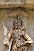 Hirapur - the Sixtyfour Yoginis Temple, Katyayani n 3 (clockwise) holding a katari (knife) and a skull cup, an  attendant holds an umbrella over her head.