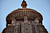 Orissa - Bhubaneswar, Lingaraj Temple. The deul topped by the amla (the typical Orissan flattened ribbed sphere) supported by deulacharinis or seated divinities.